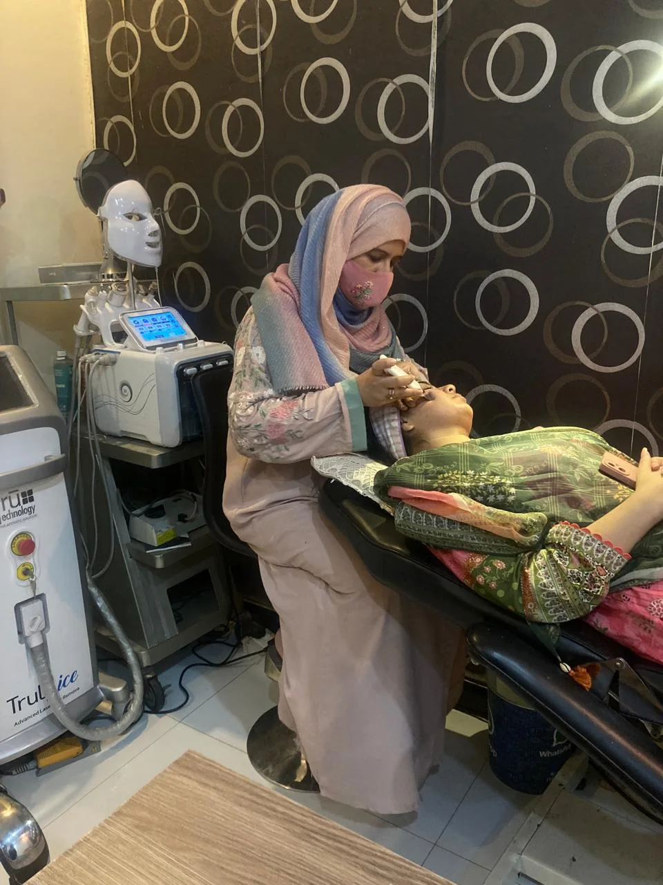 Dr Maria Umer performing a facial skin procedure in her Lahore clinic